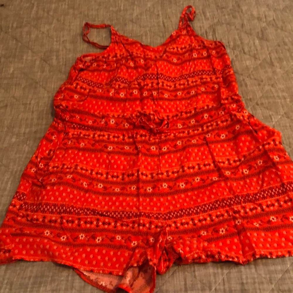 Cute orange flower print romper with spaghetti straps.